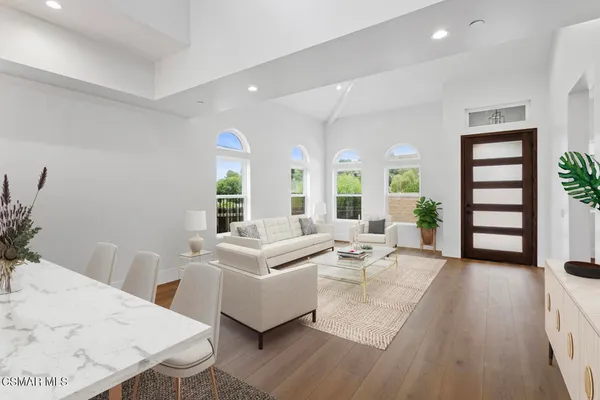 a living room with furniture and wooden floor