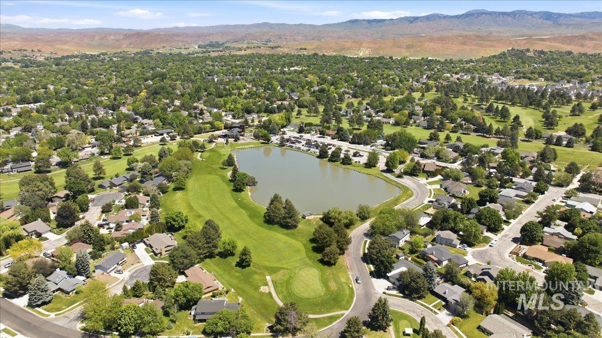 599 Pebble Beach Way Eagle, ID 83616 - Photo 42 of 44 Aerial perspective showcasing a residential community with a central lake and adjacent golf course
