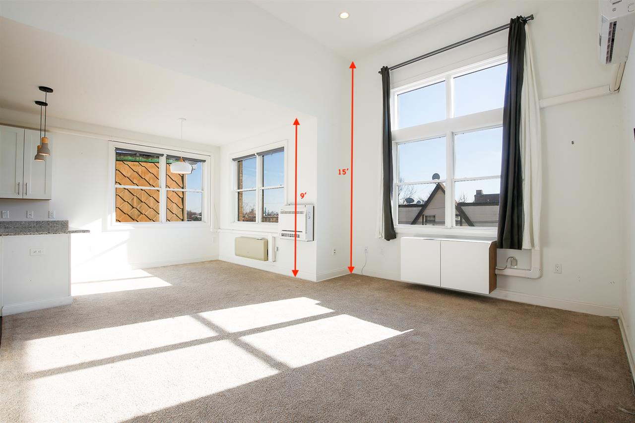 a view of a room with window and wooden floor