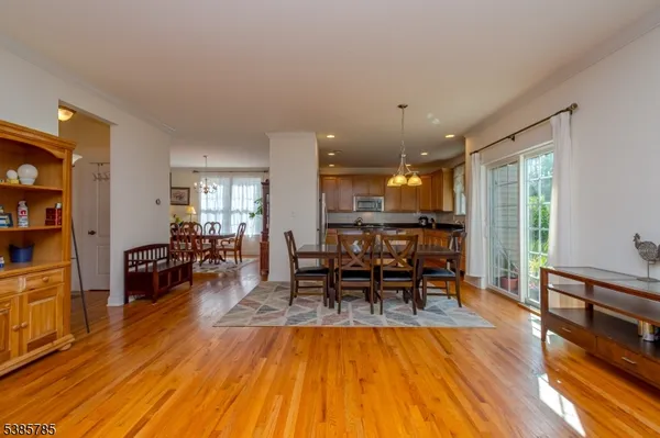 a dining room with furniture and wooden floor