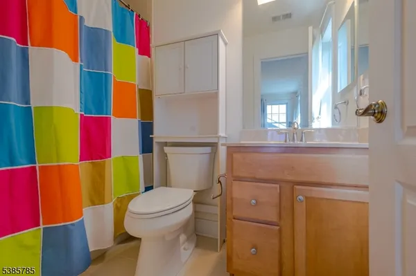 a bathroom with a toilet and a mirror
