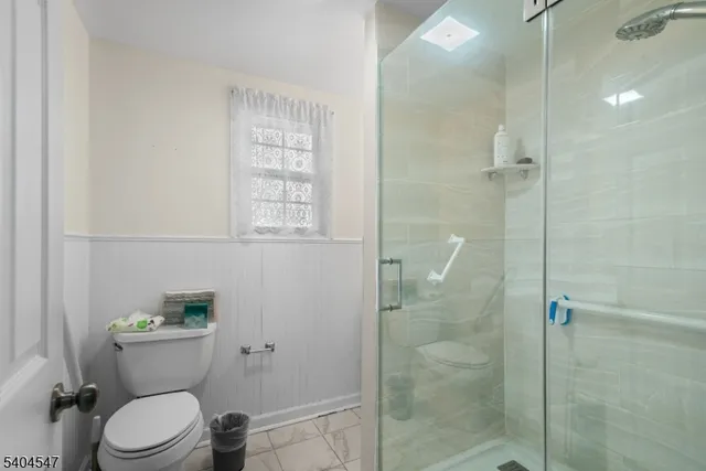 a white toilet sitting next to a bathroom sink
