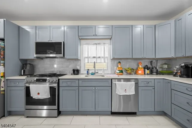 a kitchen with cabinets appliances and a sink