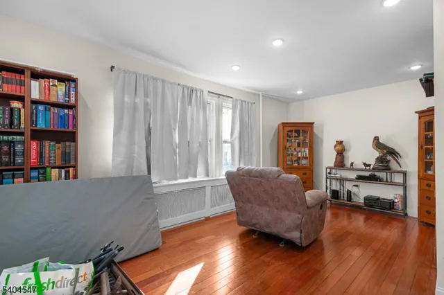 a living room with furniture and a book shelf