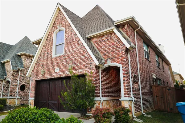 a view of a house with brick walls and windows