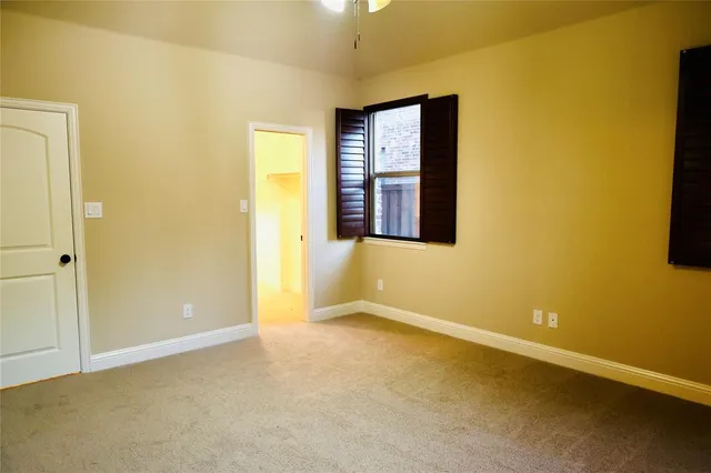 an empty room with windows and entrance