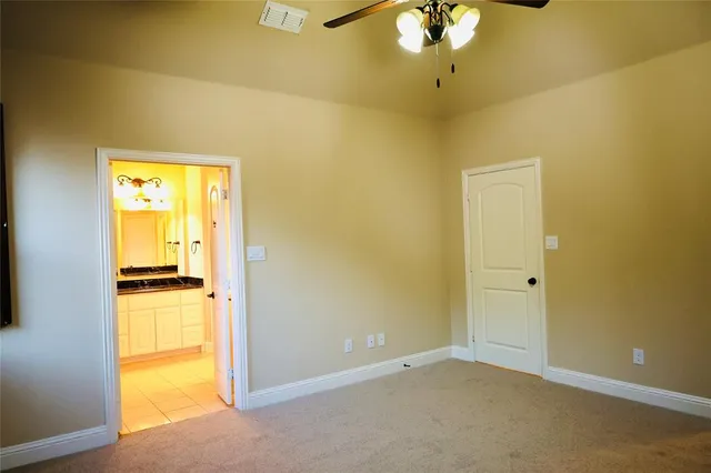 a view of a room with a window and a ceiling fan