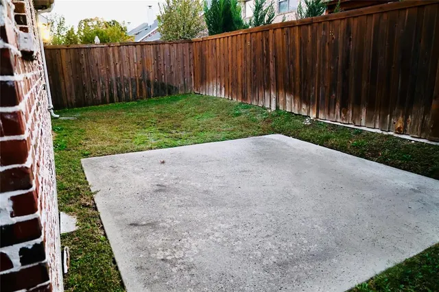 a view of a backyard with wooden fence