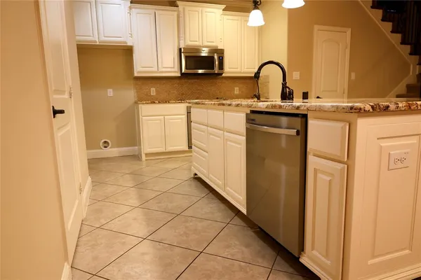 a view of a kitchen with sink and washing machine