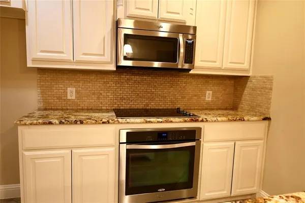 a stove top oven sitting inside of a kitchen
