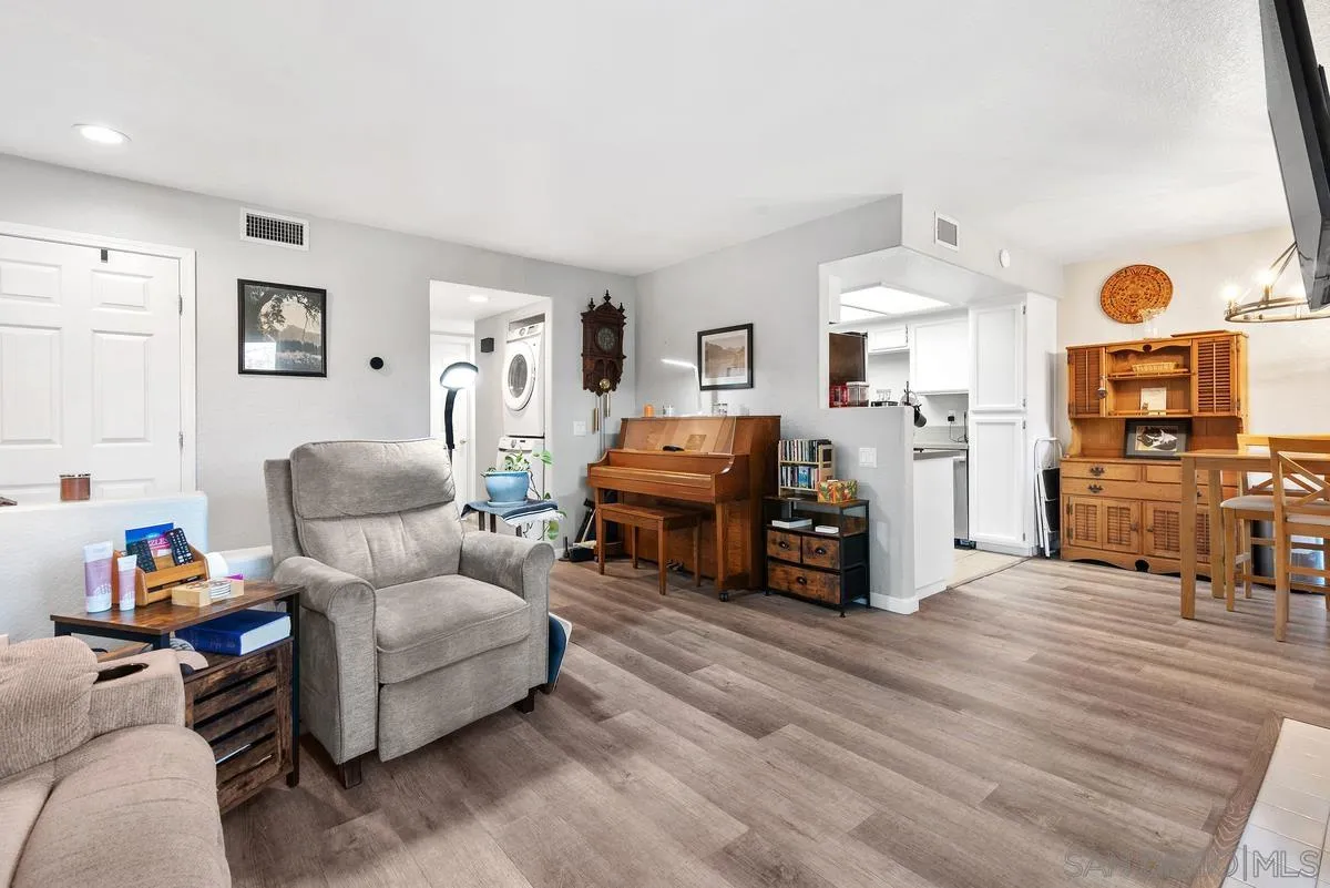a bedroom with furniture and a wooden floor
