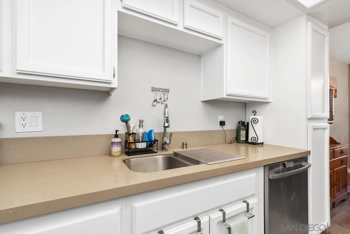 13975 Midland Road Poway, CA 92064 - Photo 13 of 33 a kitchen with kitchen island granite countertop a sink a stove and cabinets