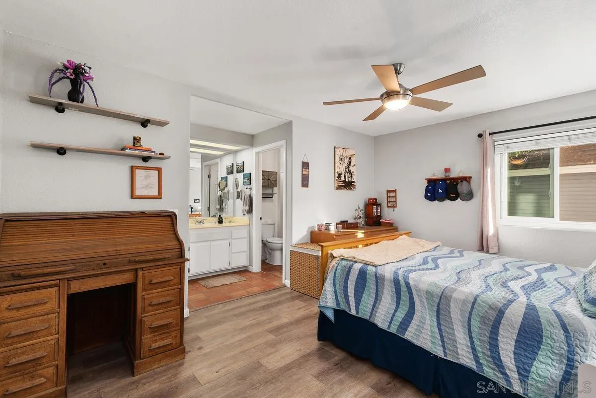 13975 Midland Road Poway, CA 92064 - Photo 16 of 33 a bedroom with a bed and wooden floor