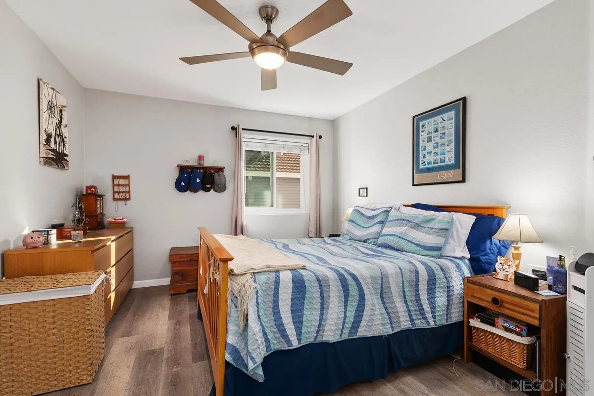 13975 Midland Road Poway, CA 92064 - Photo 17 of 33 a bedroom with a bed and a chandelier