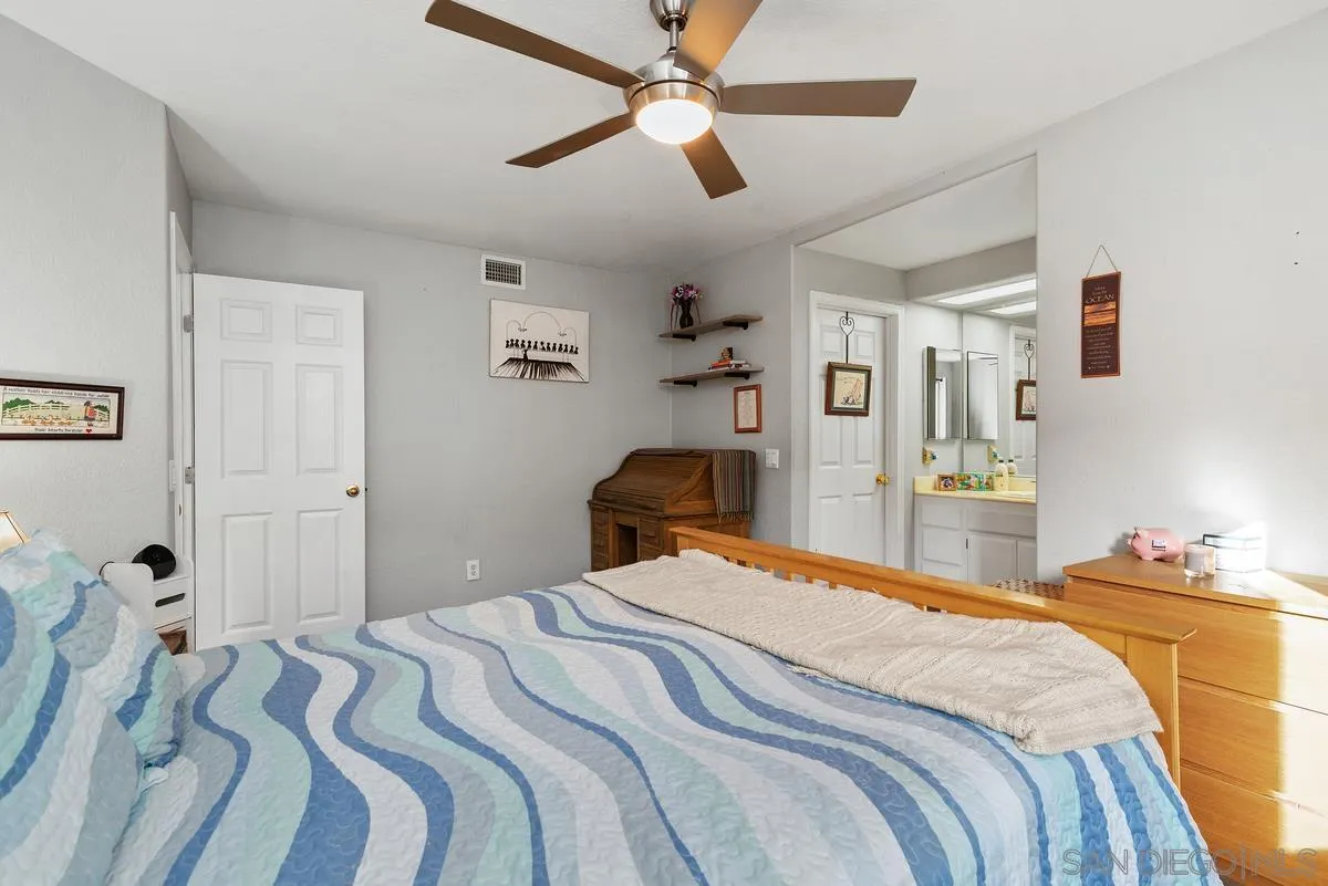 13975 Midland Road Poway, CA 92064 - Photo 18 of 33 a bedroom with a bed and wooden floor