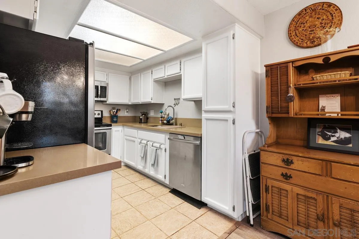 13975 Midland Road Poway, CA 92064 - Photo 9 of 33 a kitchen with granite countertop a sink a stove and refrigerator