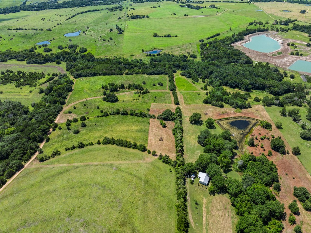1190 North Nassau Road Round Top, TX 78954 - Photo 2 of 37 an aerial view of residential houses with outdoor space and trees