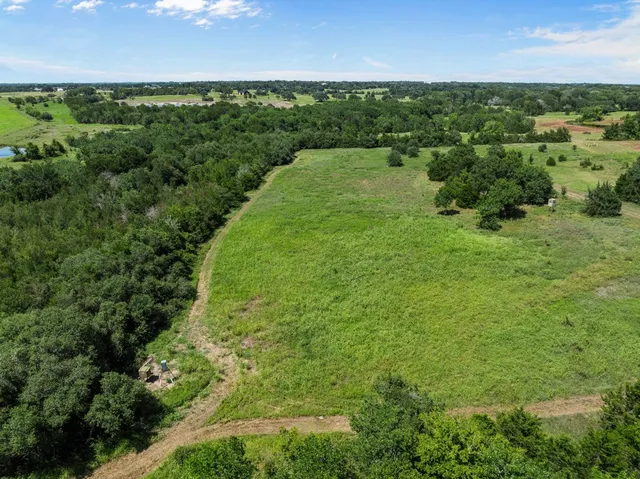 a view of a green field with an outdoor space