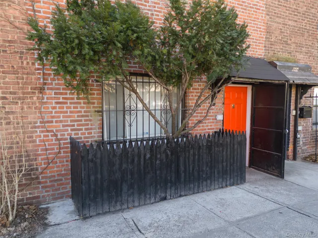a backyard of a house with wooden fence and trees