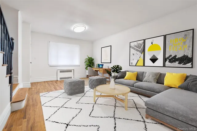 a living room with furniture and painting on the wall