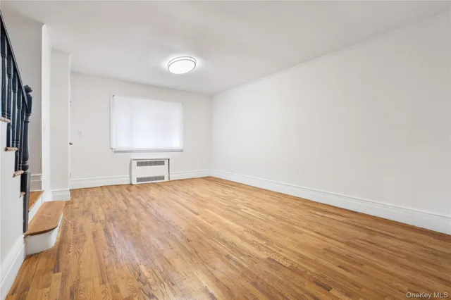 a view of an empty room and wooden floor