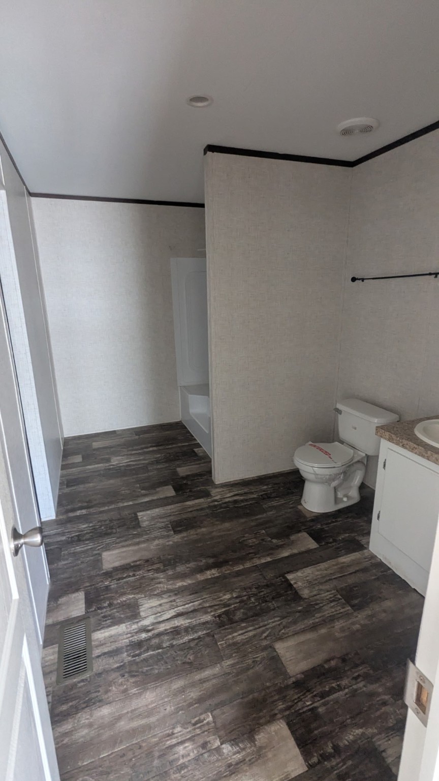 15695 Schank Road Conroe, TX 77306 - Photo 11 of 14 a bathroom with a toilet and a shower
