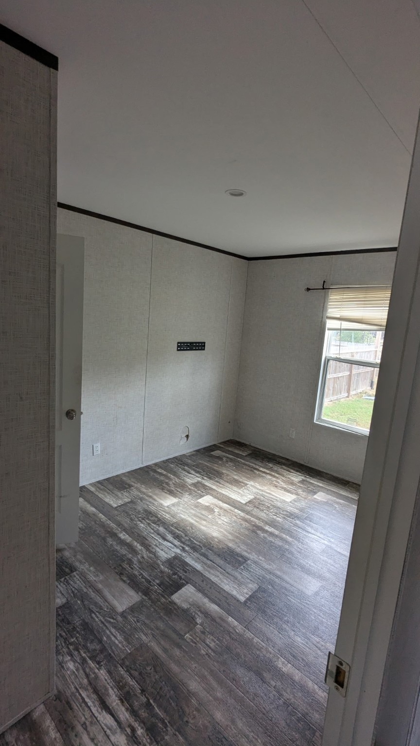 15695 Schank Road Conroe, TX 77306 - Photo 12 of 14 a view of empty room with window and wooden floor