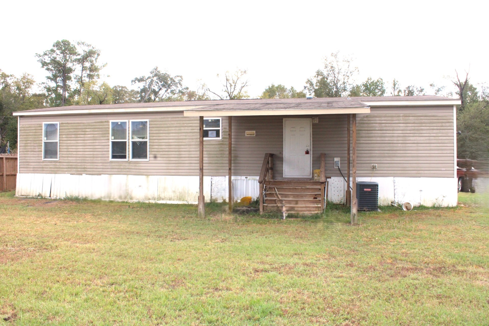 15695 Schank Road Conroe, TX 77306 - Photo 13 of 14 a view of a house with a yard and sitting area