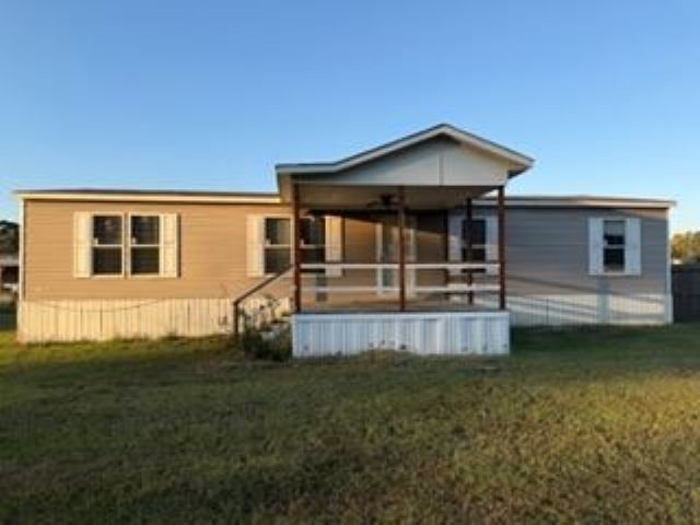 15695 Schank Road Conroe, TX 77306 - Photo 2 of 14 a front view of a house with garden