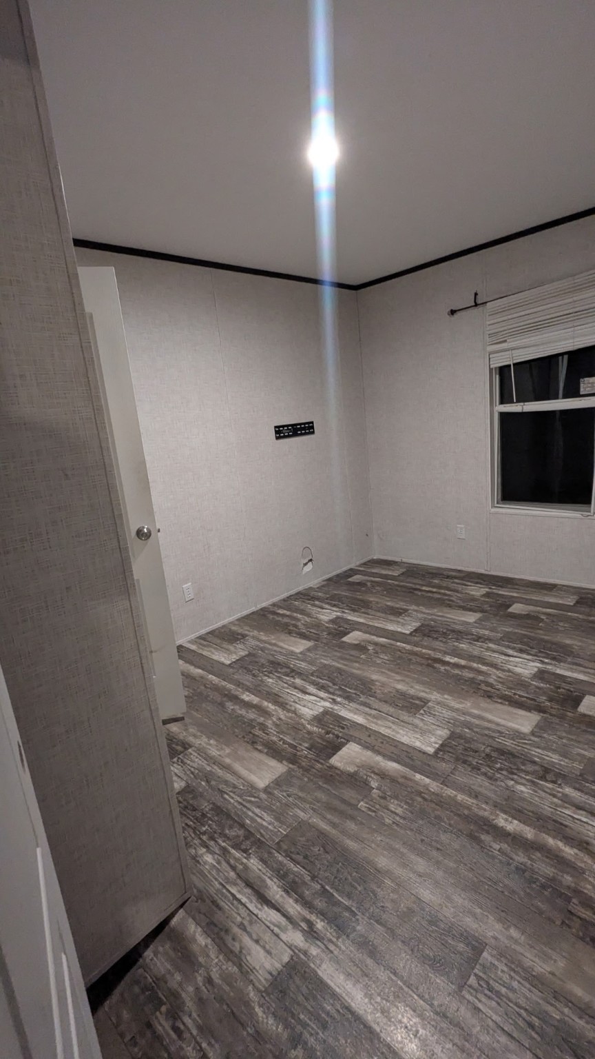 15695 Schank Road Conroe, TX 77306 - Photo 3 of 14 a view of empty room with wooden floor