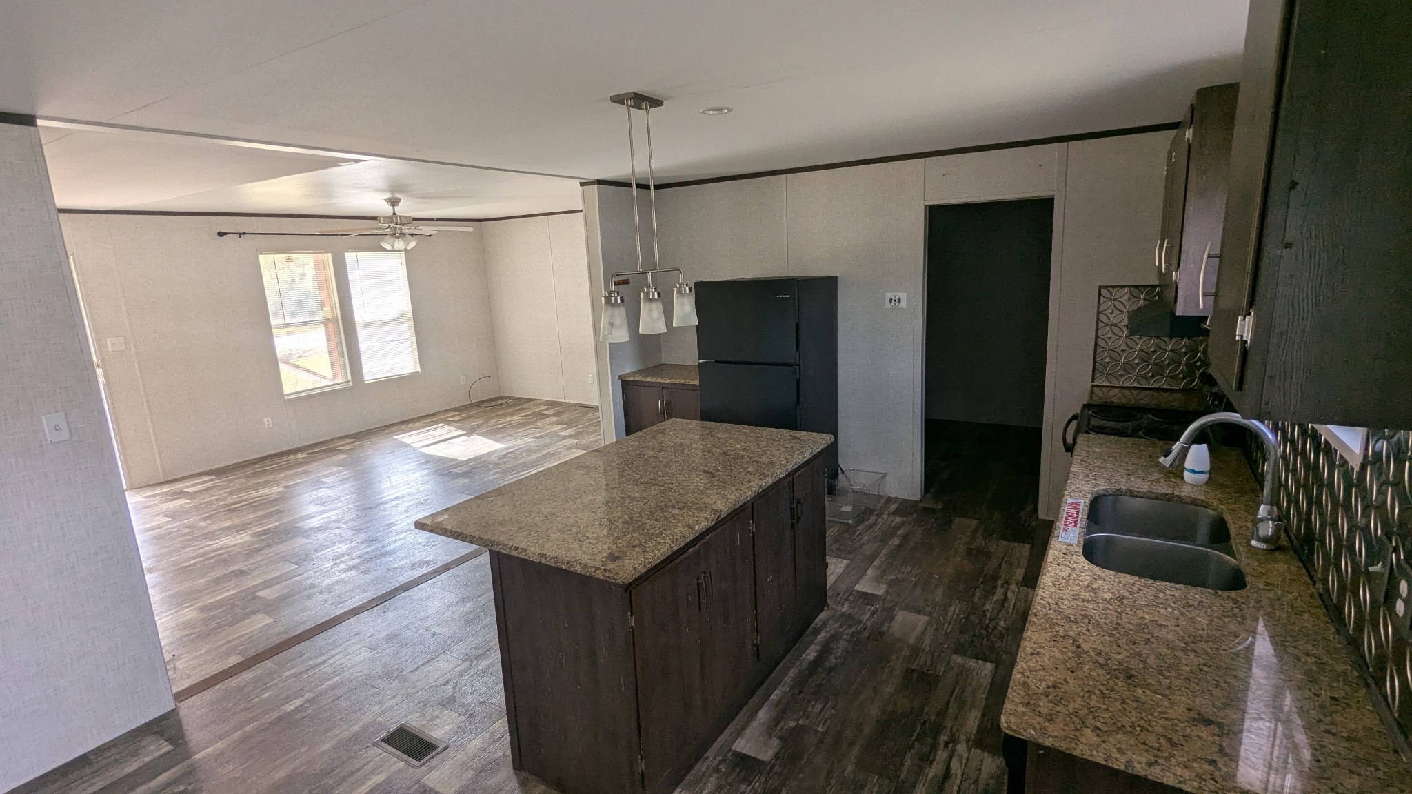 15695 Schank Road Conroe, TX 77306 - Photo 6 of 14 a kitchen with kitchen island a sink stove and refrigerator