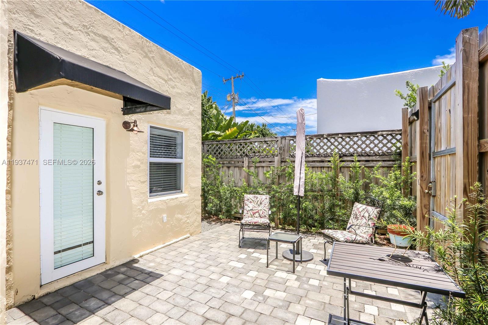 2477 Southwest 22nd Terrace Miami, FL 33145 - Photo 12 of 14 a view of a patio with a table and chairs and potted plants