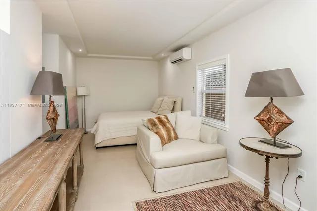 a bedroom with furniture and a lamp