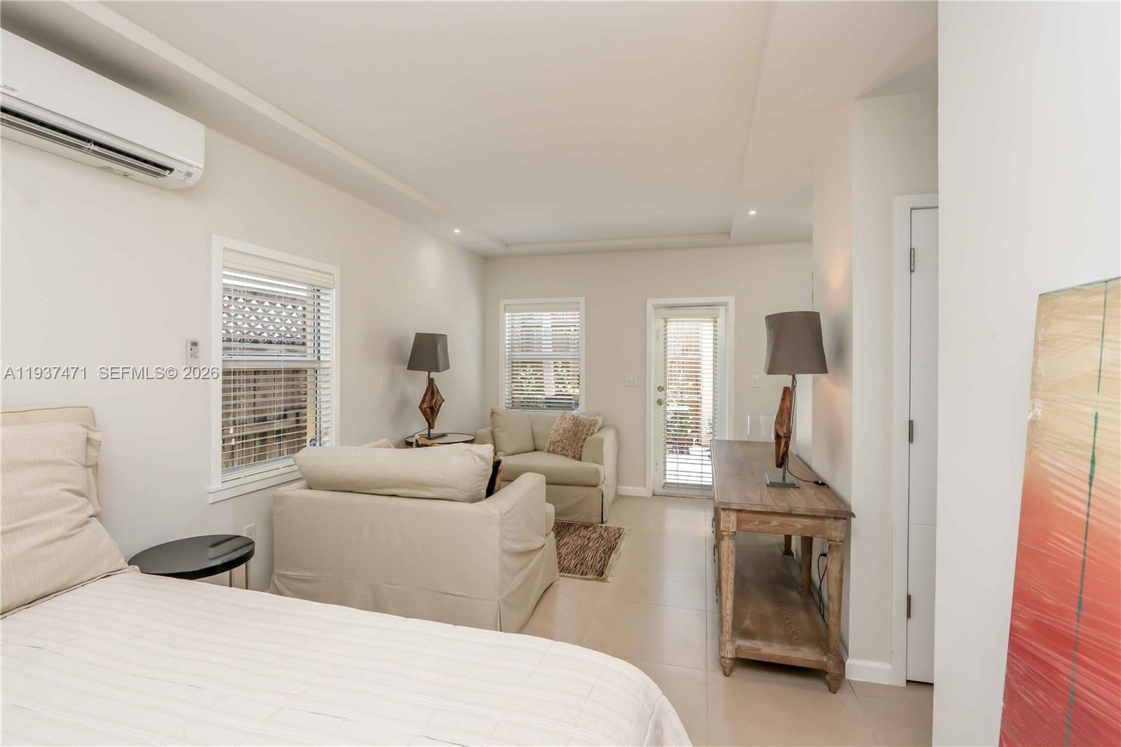 2477 Southwest 22nd Terrace Miami, FL 33145 - Photo 8 of 14 a bedroom with a bed and a large window