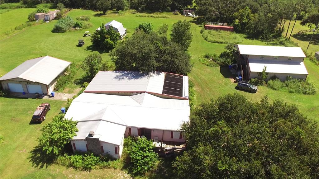 an aerial view of a house with a yard basket ball court and outdoor seating