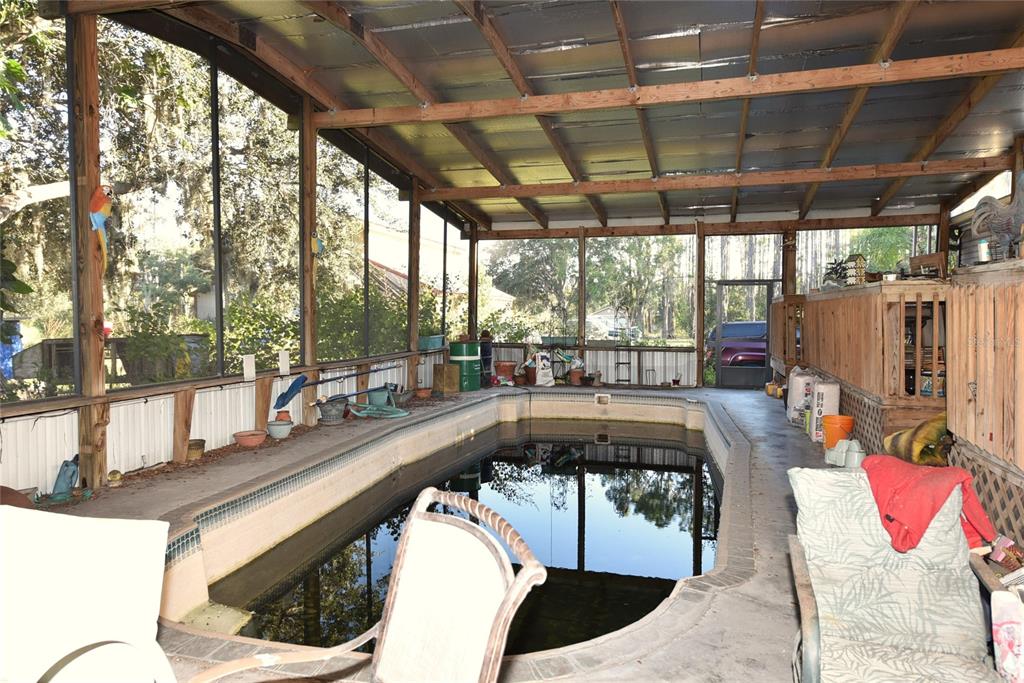 11542 Sumner Road Wimauma, FL 33598 - Photo 11 of 65 a swimming pool with outdoor seating and yard