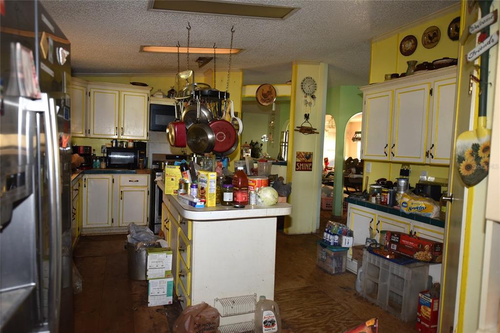 11542 Sumner Road Wimauma, FL 33598 - Photo 15 of 65 a kitchen that has a lot of cabinets and refrigerator