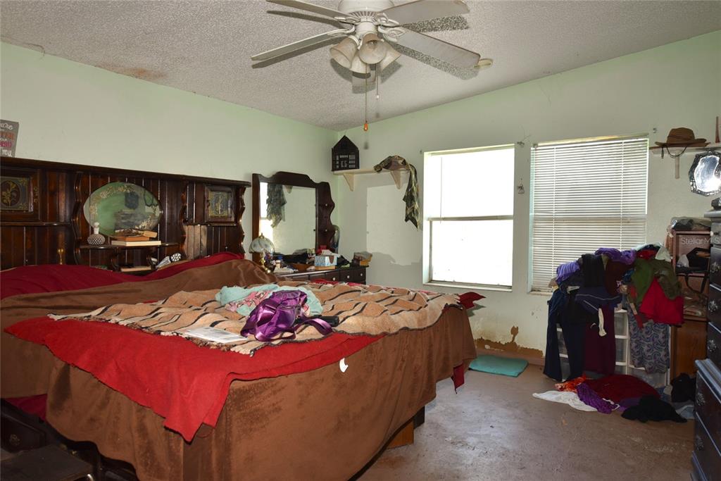 11542 Sumner Road Wimauma, FL 33598 - Photo 16 of 65 a bedroom with bed a mirror and window