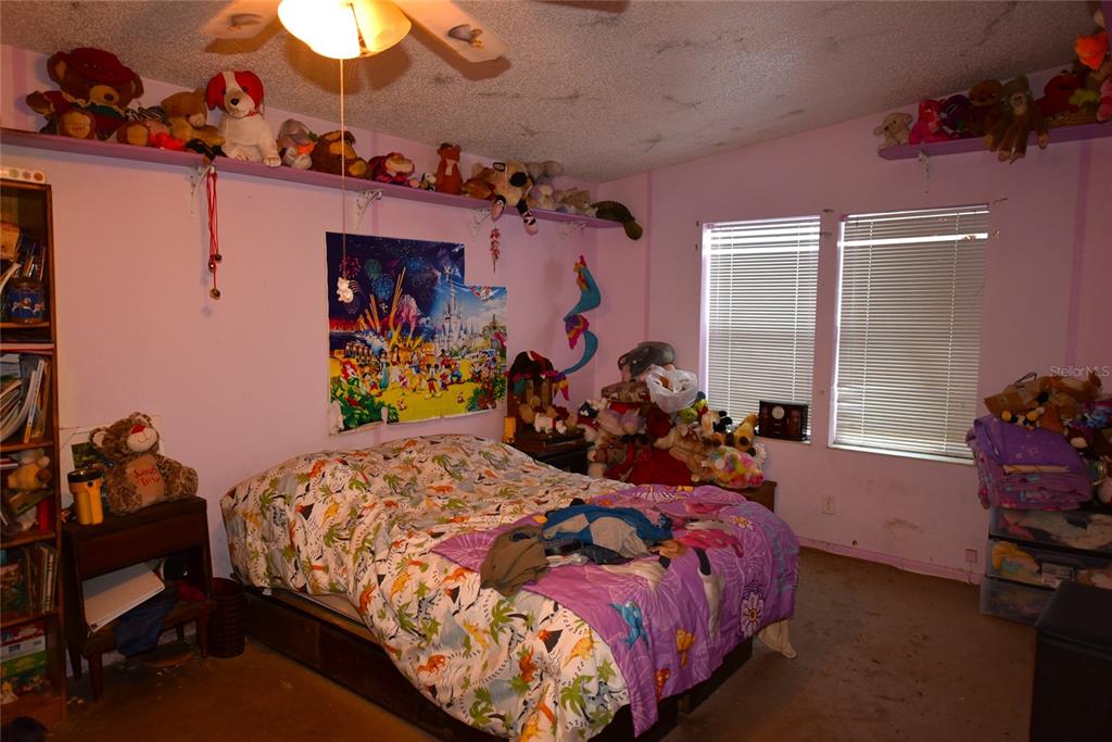 11542 Sumner Road Wimauma, FL 33598 - Photo 19 of 65 a bed room with a bed and a closet
