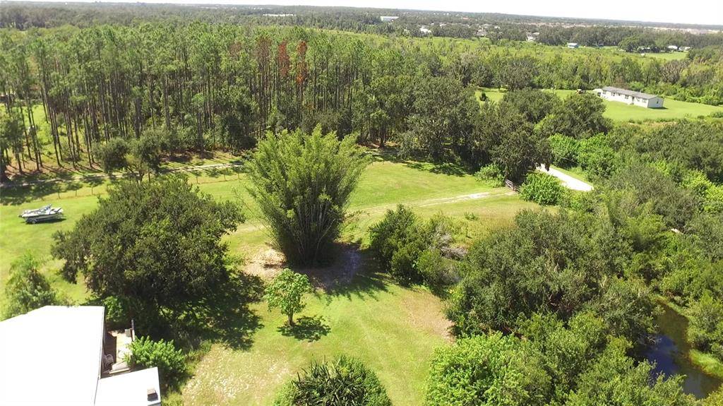 11542 Sumner Road Wimauma, FL 33598 - Photo 2 of 65 a view of a forest with a lake
