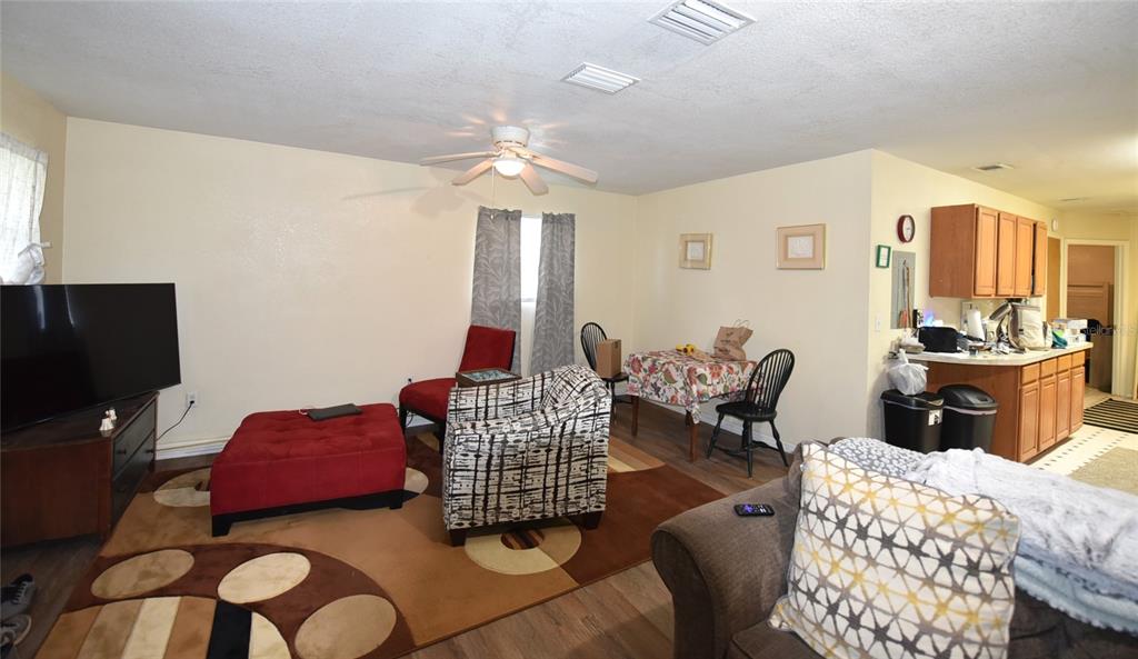 11542 Sumner Road Wimauma, FL 33598 - Photo 25 of 65 a bedroom with furniture and wooden floor