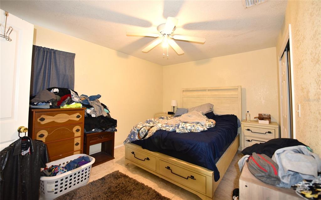 11542 Sumner Road Wimauma, FL 33598 - Photo 29 of 65 a living room with furniture and a chandelier