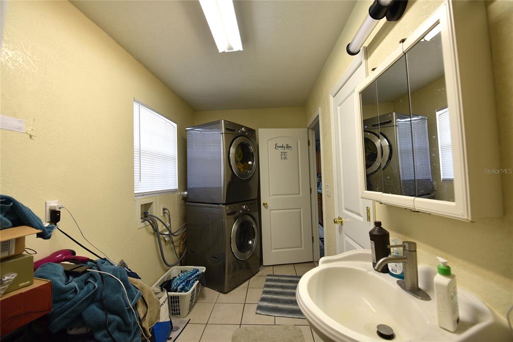 11542 Sumner Road Wimauma, FL 33598 - Photo 30 of 65 a bathroom with a sink mirror and window