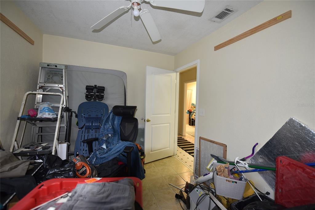 11542 Sumner Road Wimauma, FL 33598 - Photo 32 of 65 a room with furniture and a gym machine