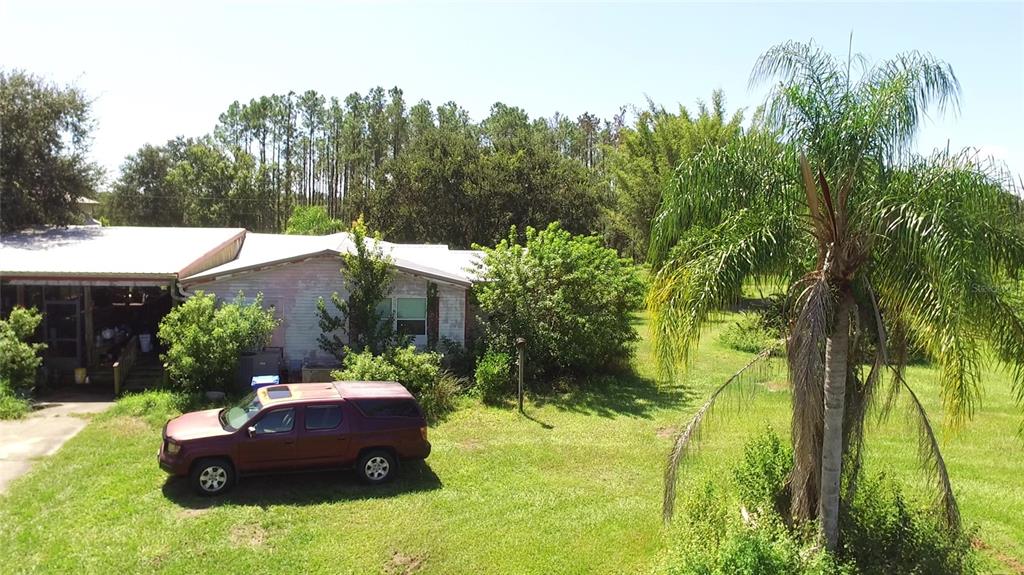 11542 Sumner Road Wimauma, FL 33598 - Photo 8 of 65 a view of a house with backyard and a garden