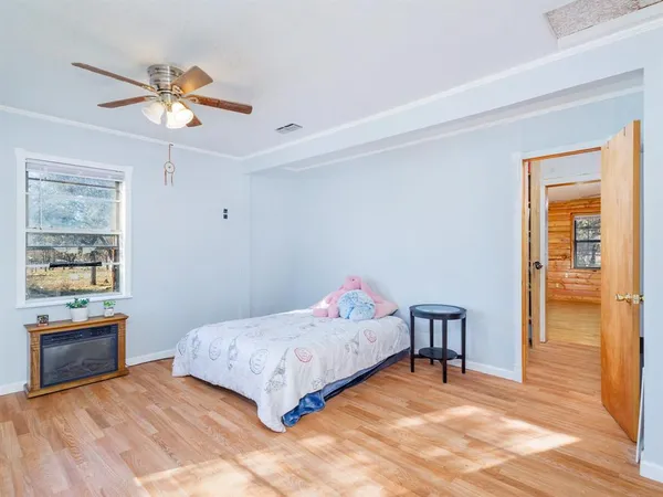 a bedroom with a bed and a chandelier