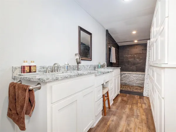 a bathroom with a sink a vanity and a mirror