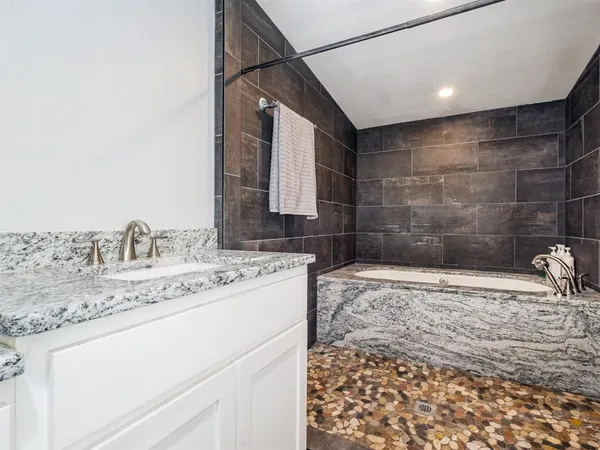 a bathroom with a granite countertop sink a toilet and a mirror
