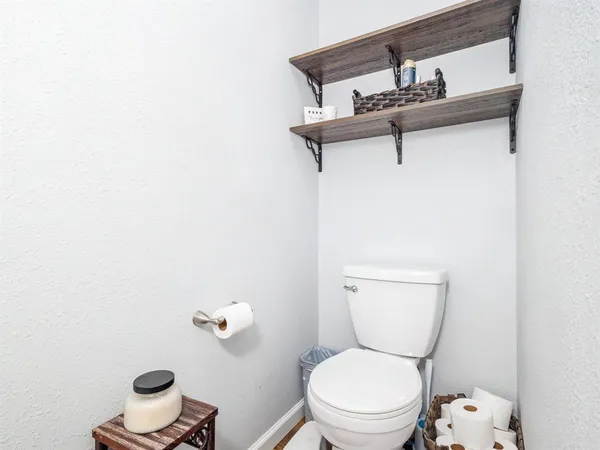 a white toilet sitting next to a small bathroom