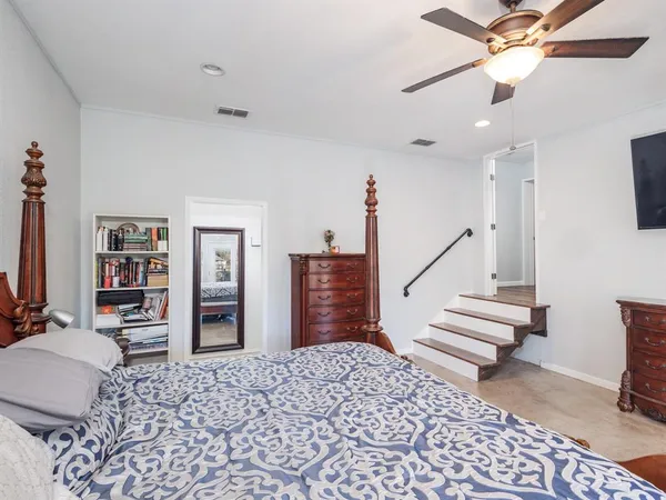 a bedroom with a bed and a book shelf